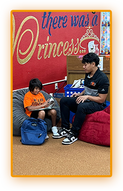 Two students sitting in comfy chairs